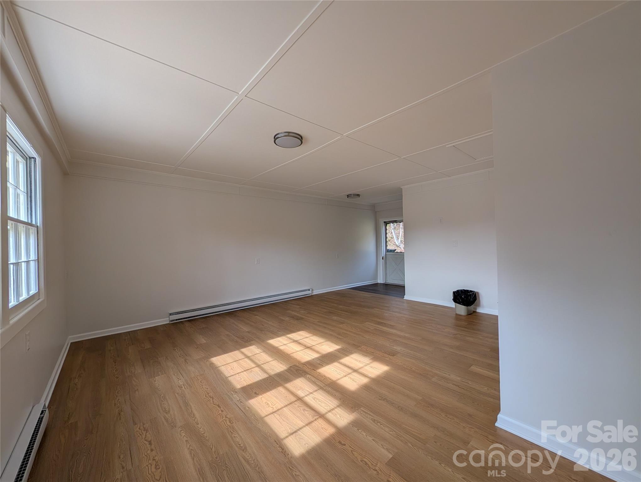 945 Summers Road Valdese, NC 28690 - Photo 19 of 25 a view of an empty room with wooden floor and a window