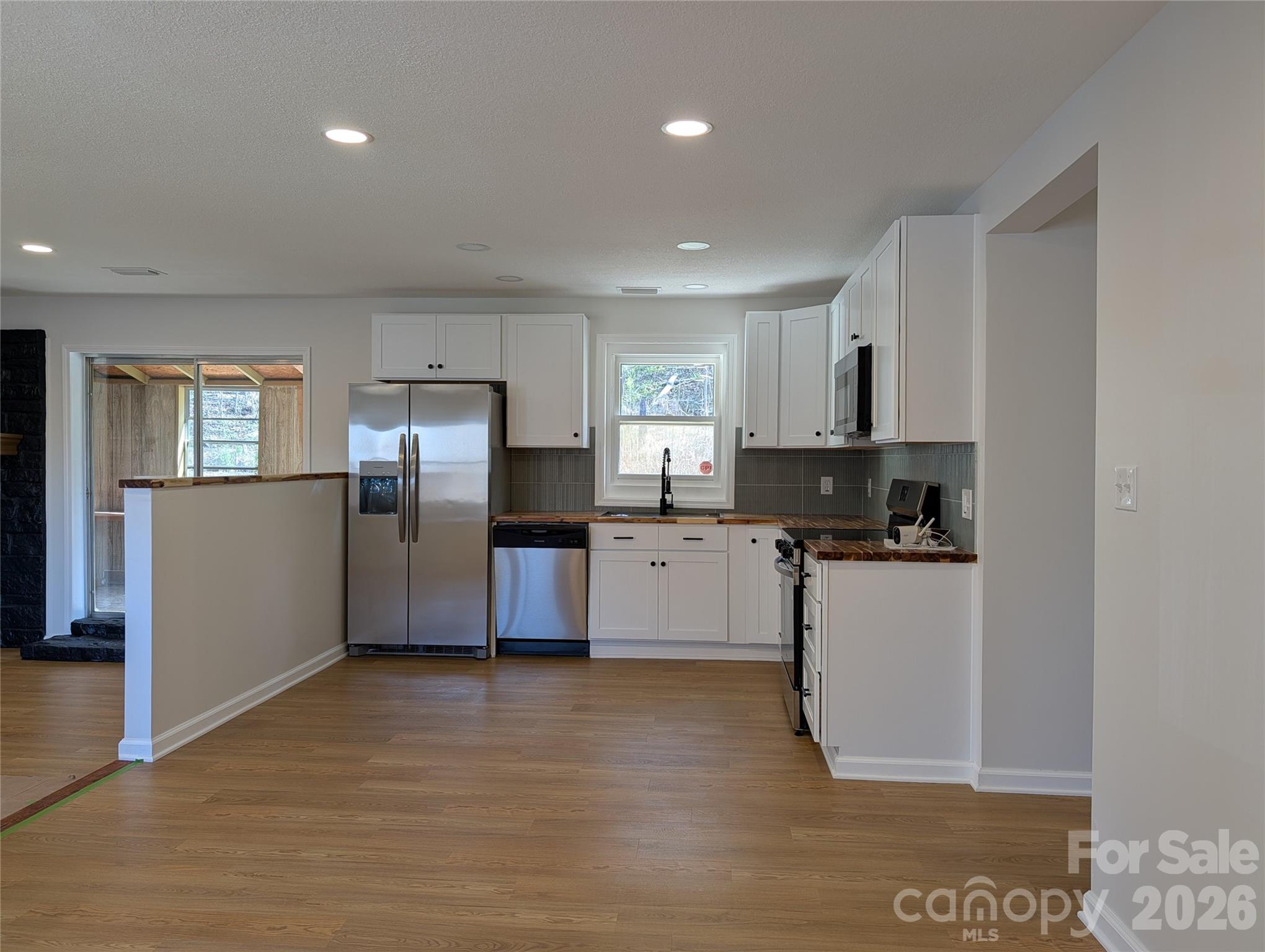 945 Summers Road Valdese, NC 28690 - Photo 3 of 25 a kitchen with stainless steel appliances a refrigerator sink and microwave