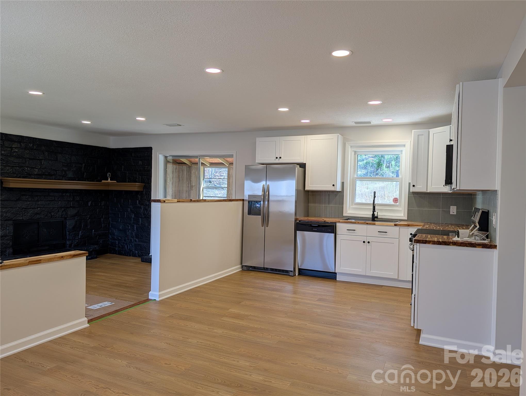 945 Summers Road Valdese, NC 28690 - Photo 3 of 25 a open kitchen with stainless steel appliances granite countertop a refrigerator and a stove top oven