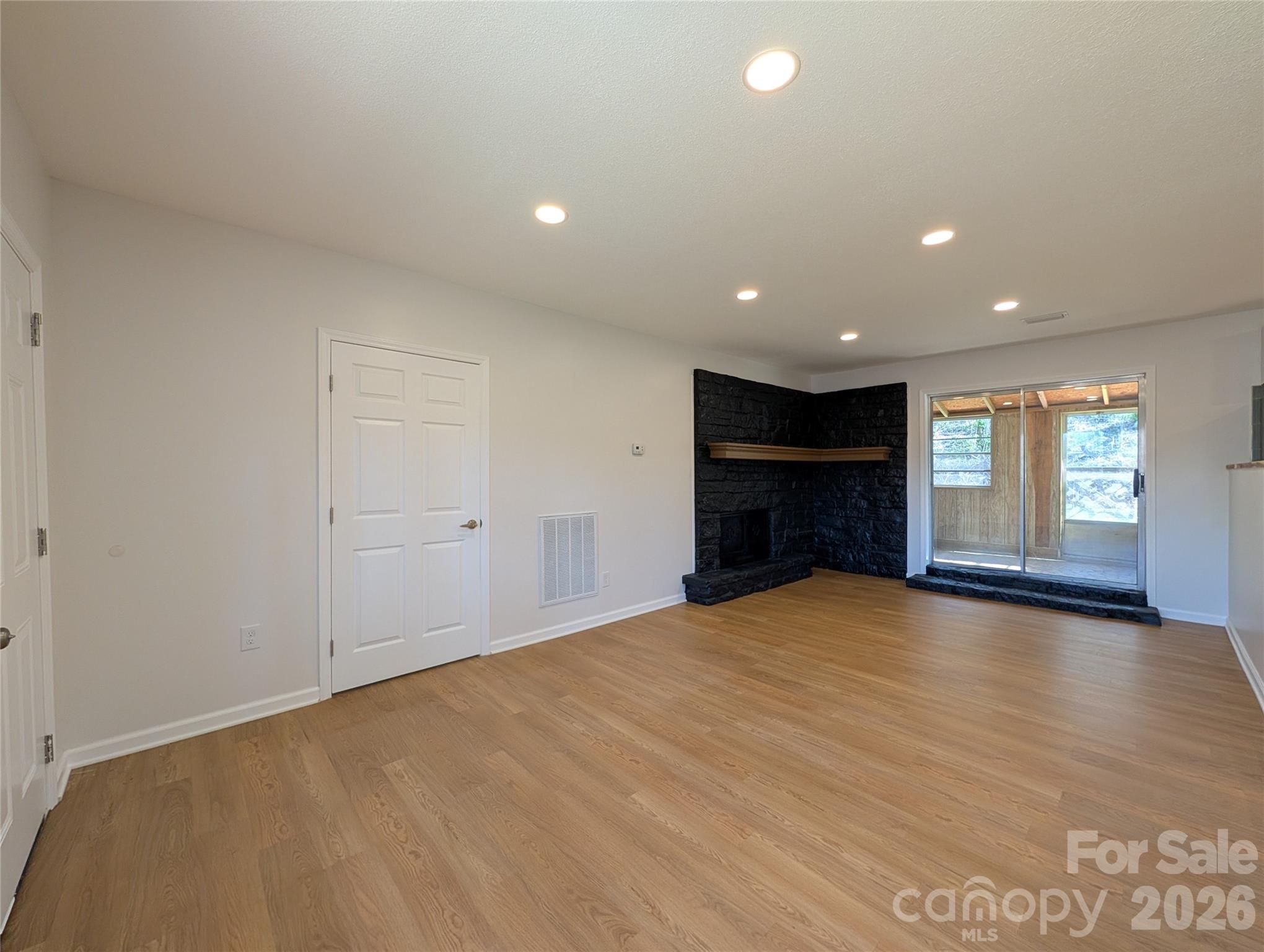945 Summers Road Valdese, NC 28690 - Photo 5 of 25 a view of an empty room with a window and fire place