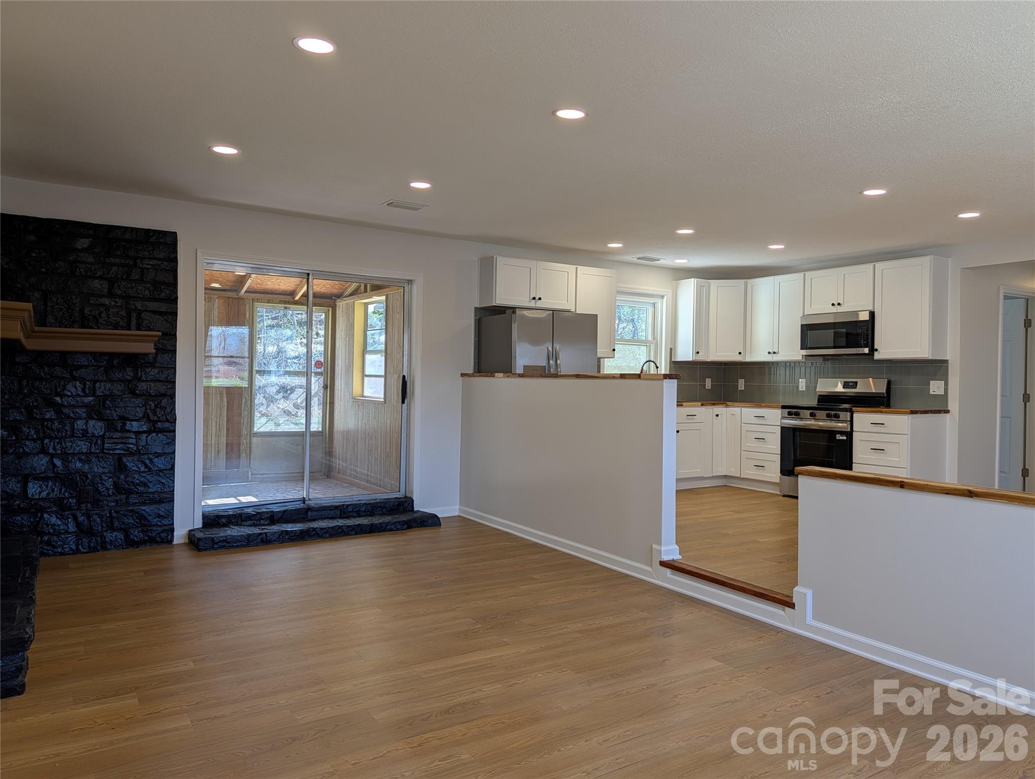 945 Summers Road Valdese, NC 28690 - Photo 9 of 25 a kitchen with stainless steel appliances granite countertop a refrigerator and a stove top oven