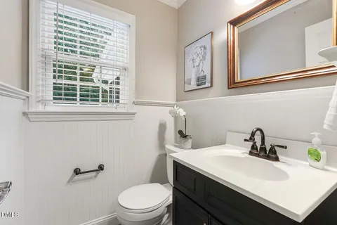 a bathroom with a sink a toilet and a window