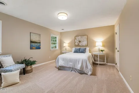 a spacious bedroom with a bed and a couch