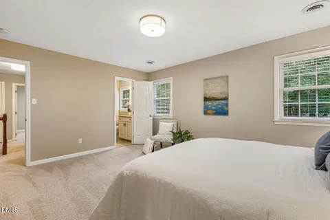 a bedroom with a large bed and a window