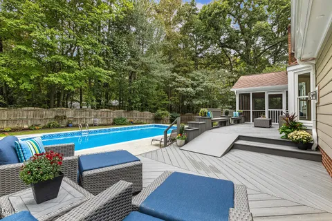 a view of swimming pool with outdoor seating and plants