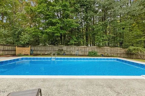 a view of a swimming pool and a yard