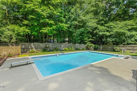 a view of a swimming pool and a yard