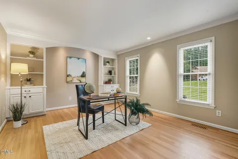 a work room with furniture and a wooden floor