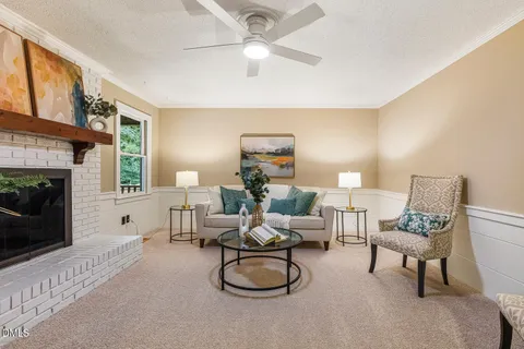 a living room with furniture a window and a fireplace