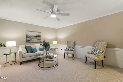 a living room with furniture and a chandelier