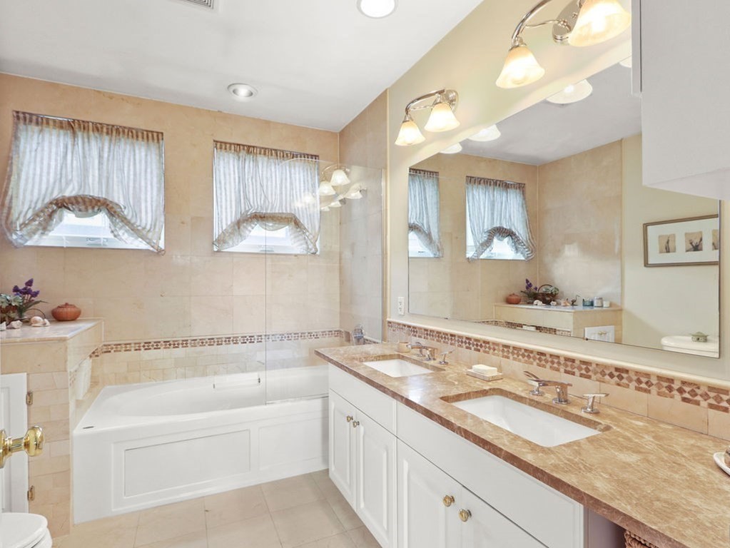 64 Constitution Road, Unit 64 Boston, MA 02129 - Photo 11 of 18 a bathroom with a granite countertop double vanity sink and a mirror