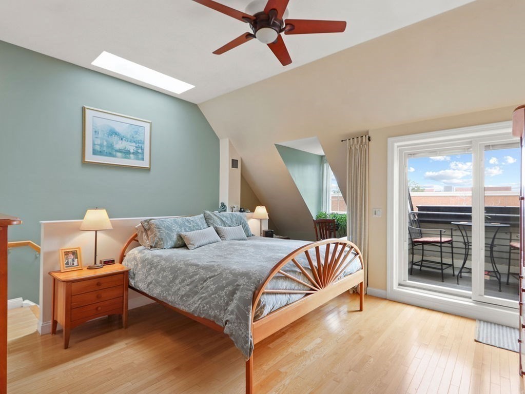 64 Constitution Road, Unit 64 Boston, MA 02129 - Photo 9 of 18 a bedroom with a bed and wooden floor