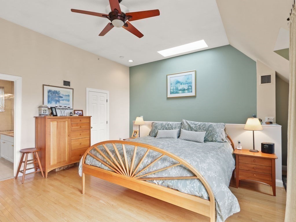 64 Constitution Road, Unit 64 Boston, MA 02129 - Photo 10 of 18 a bedroom with a bed and a table in it