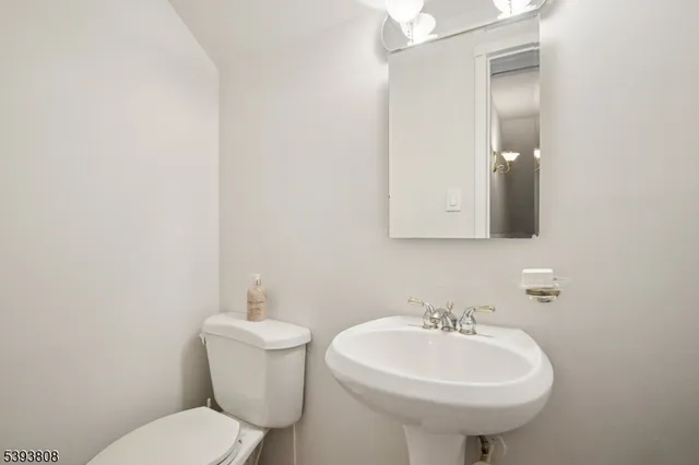 a bathroom with a sink a toilet and mirror