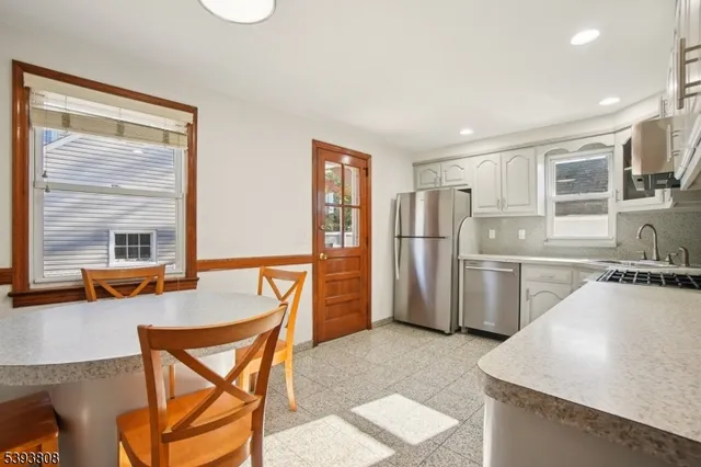 a kitchen with refrigerator and cabinets