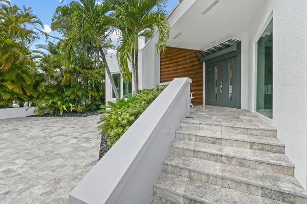 a backyard of a house with table and chairs
