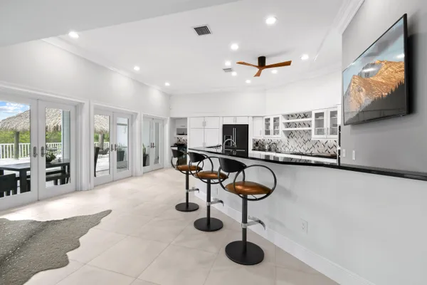 a living room with furniture a window and a ceiling fan