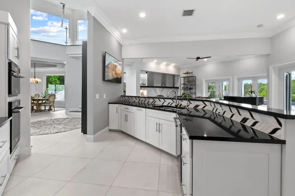 a large white kitchen with a large window
