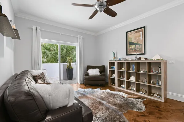 a bedroom with a bed table and a mirror