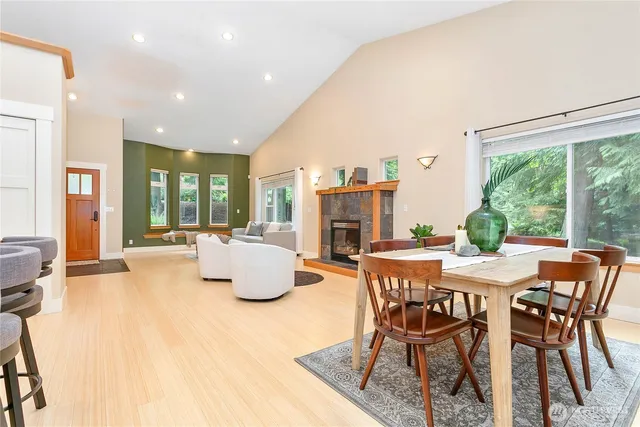 a dining room with furniture and large windows