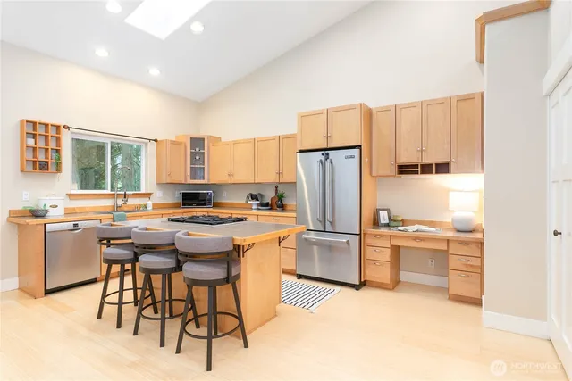 a kitchen with a table chairs refrigerator and cabinets