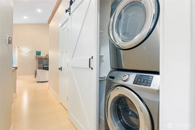 a view of a hallway with washer and dryer
