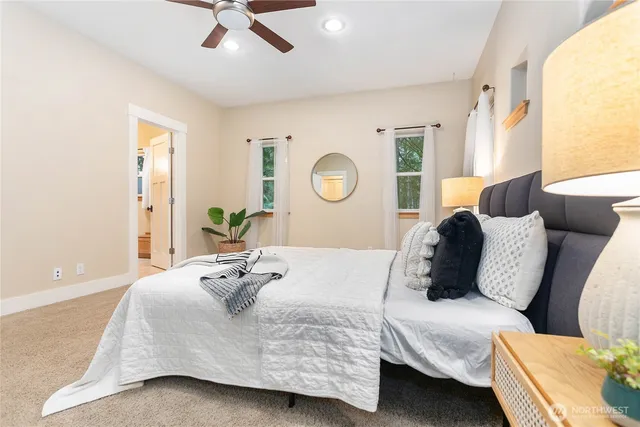 a bedroom with a bed couch and window