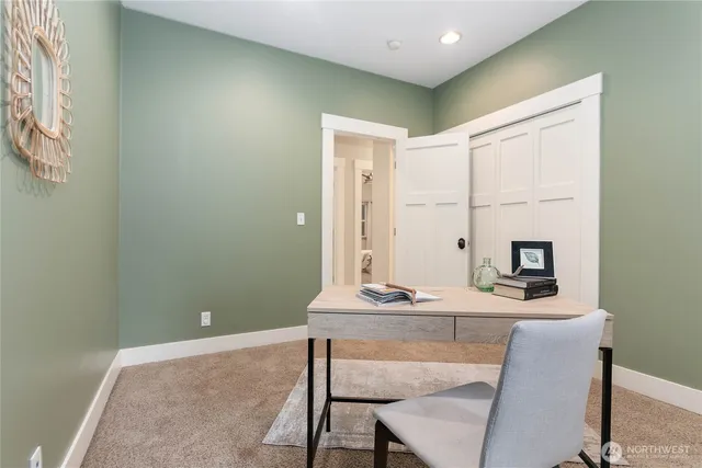 a bed sitting in a bedroom next to a window