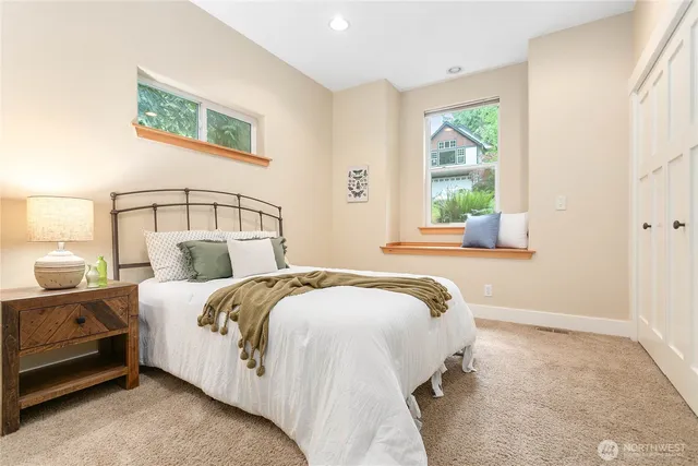 a bedroom with a bed and a chair