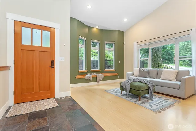 a living room with furniture and large windows