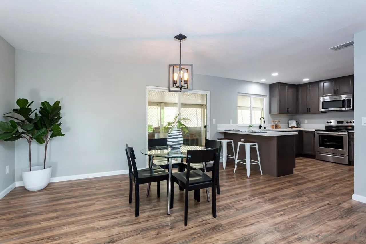 11834 Rocoso Road Lakeside, CA 92040 - Photo 11 of 28 a view of a dining room with furniture window and wooden floor