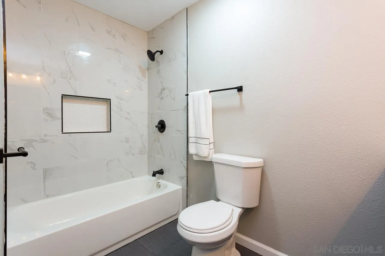 11834 Rocoso Road Lakeside, CA 92040 - Photo 26 of 28 a white toilet sitting next to a bath tub