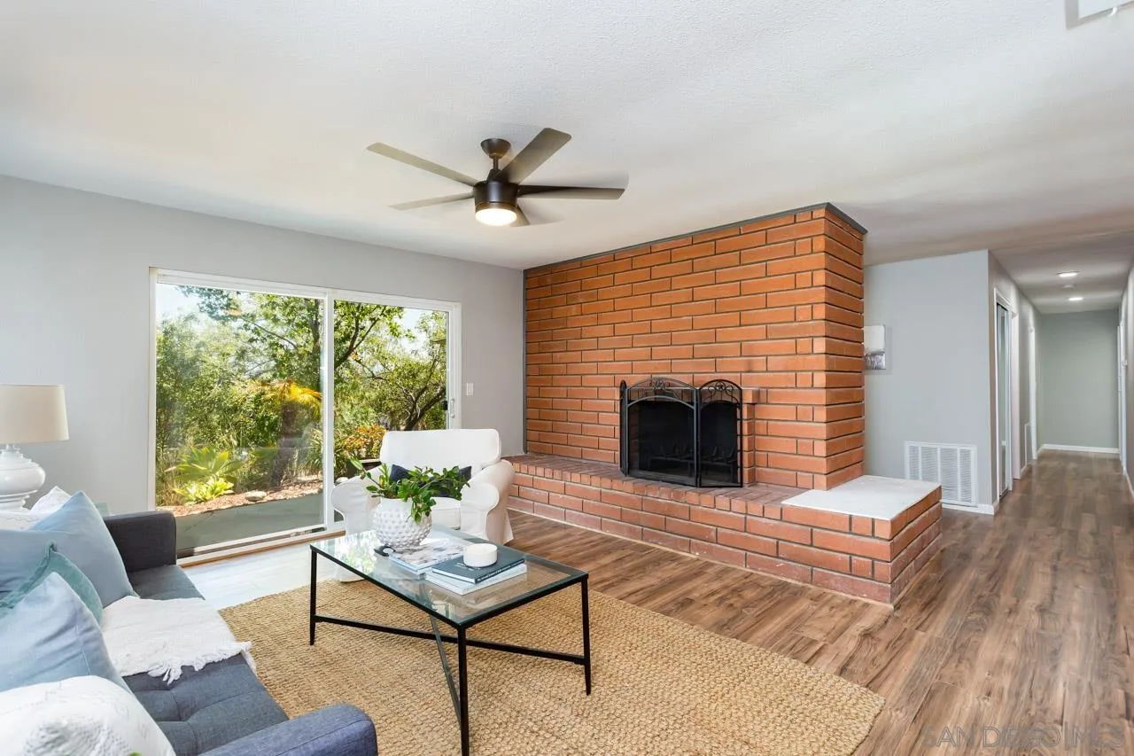 11834 Rocoso Road Lakeside, CA 92040 - Photo 3 of 28 a living room with furniture and a fireplace