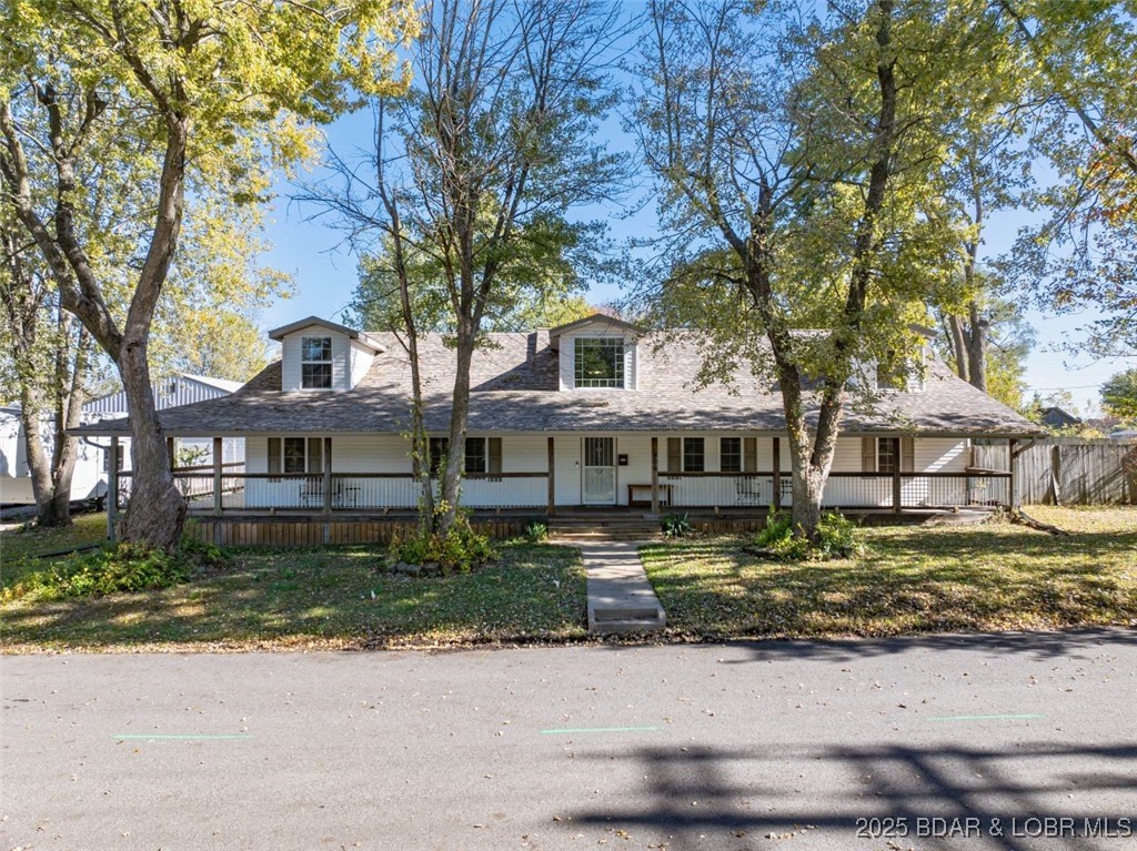 Street side w/a covered deck around 3 sides.