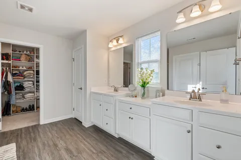 a bathroom with a double vanity sink and a mirror