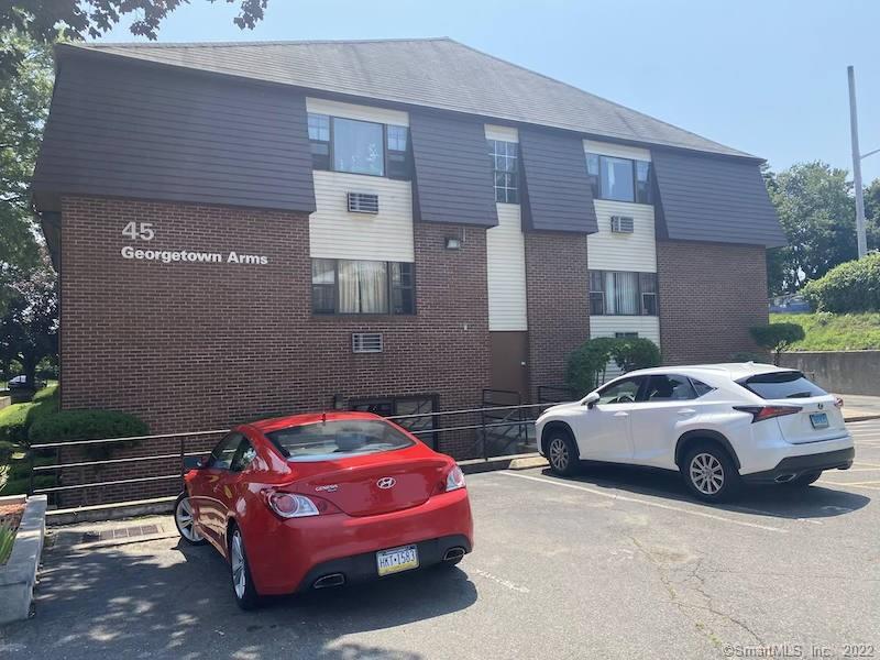 a front view of a house with parking space