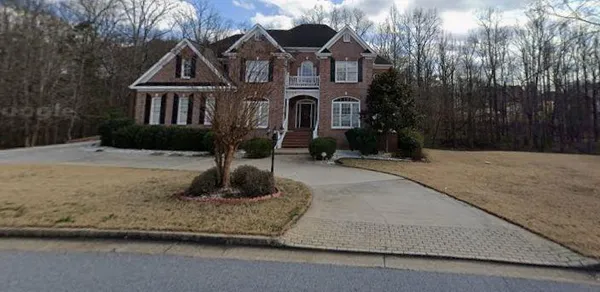a front view of a house with a yard