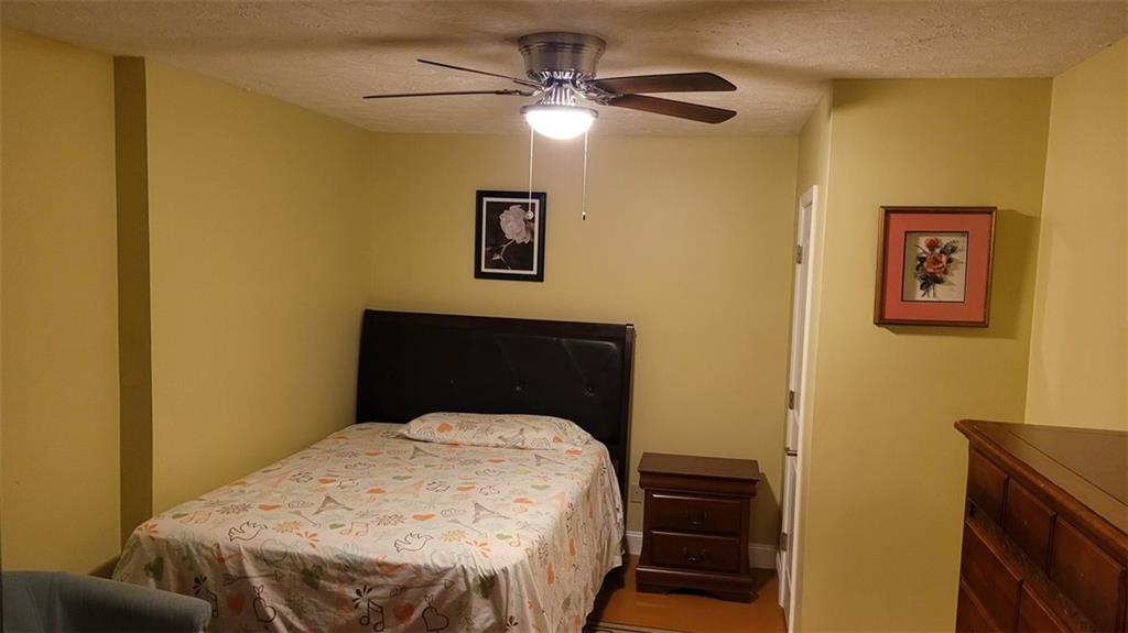 2750 Wellington Way Southeast Conyers, GA 30013 - Photo 3 of 10 a bedroom with a bed and a chandelier