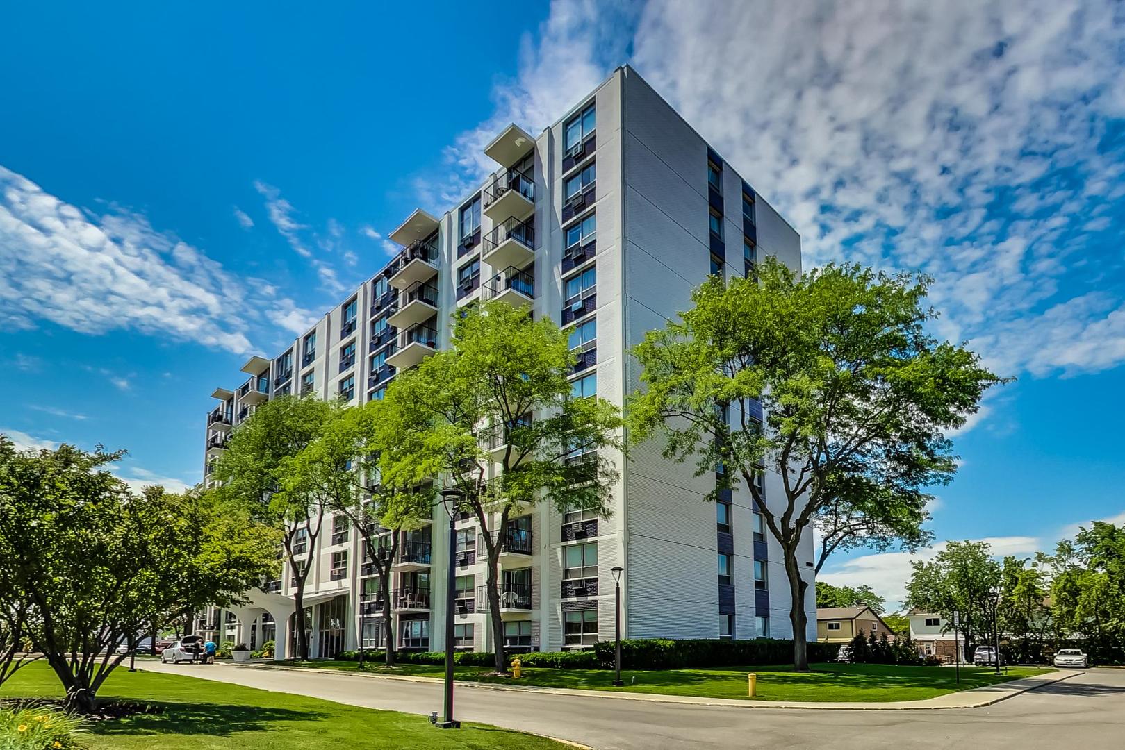 9009 Golf Road, Unit 8B Des Plaines, IL 60016 - Photo 2 of 42 a view of a tall building in a big yard with large trees