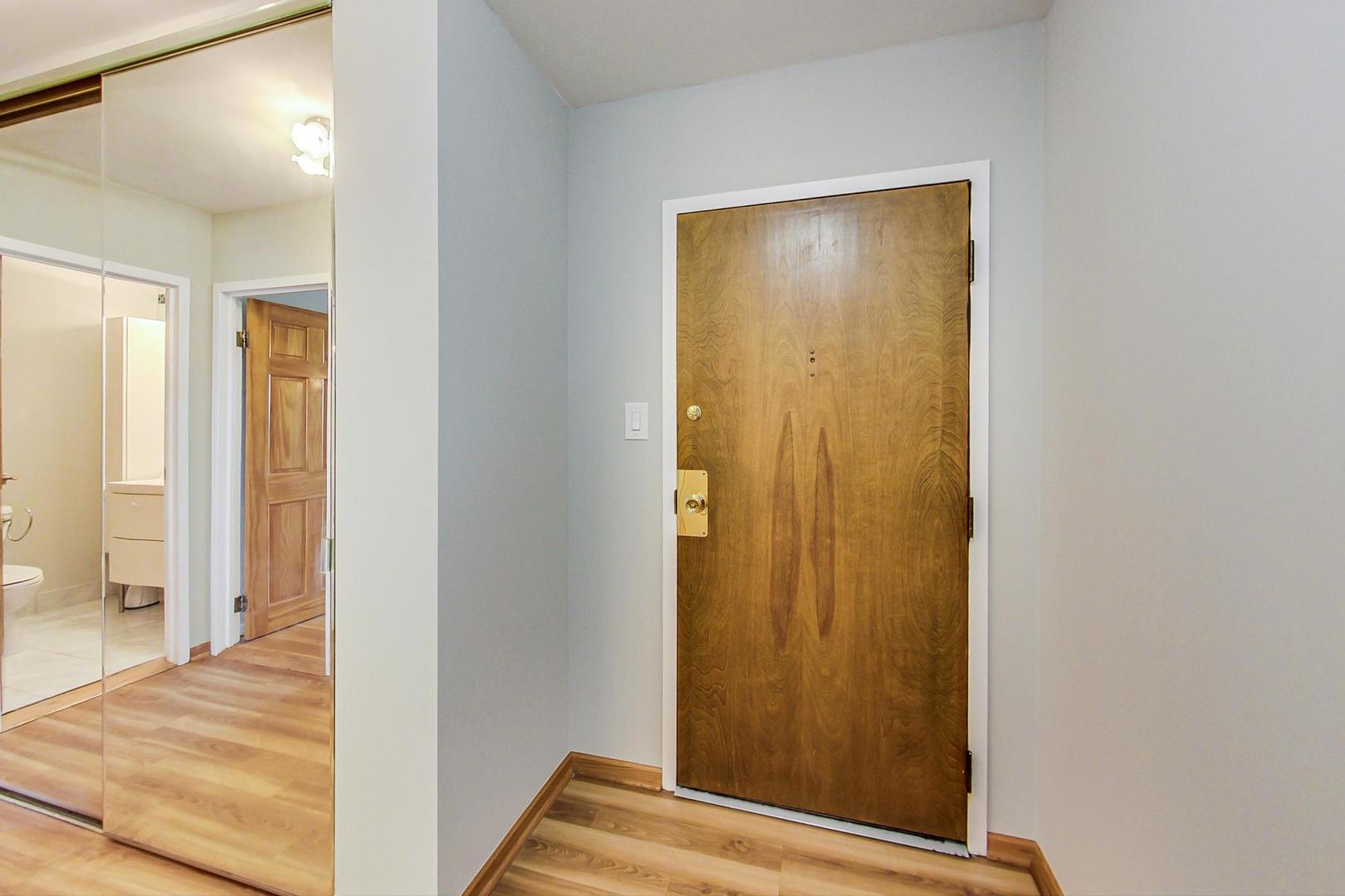 9009 Golf Road, Unit 8B Des Plaines, IL 60016 - Photo 11 of 42 a view of a hallway with wooden floor