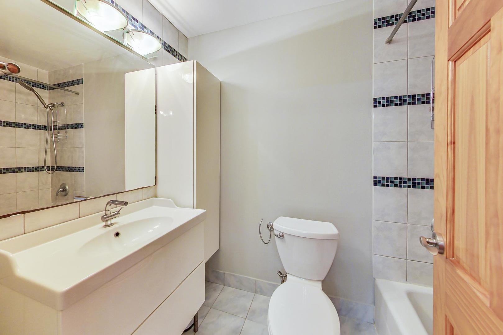 9009 Golf Road, Unit 8B Des Plaines, IL 60016 - Photo 25 of 42 a bathroom with a toilet sink and mirror