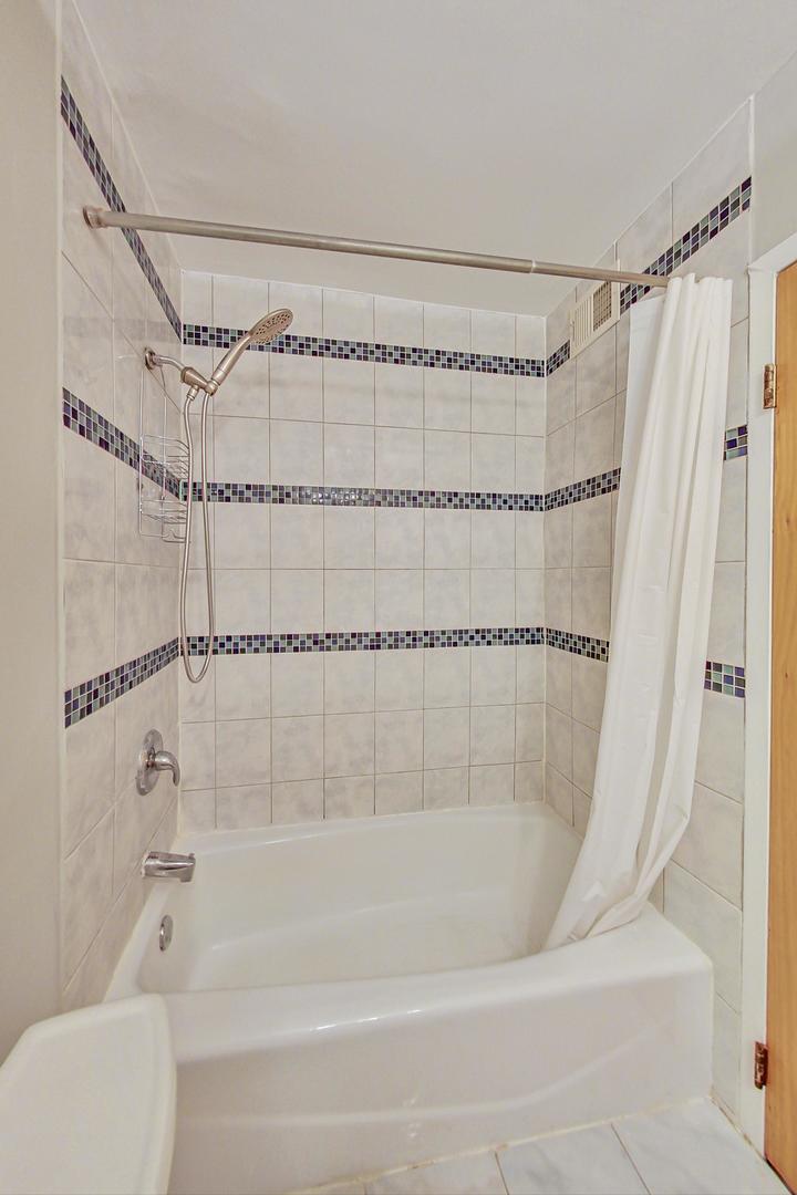 9009 Golf Road, Unit 8B Des Plaines, IL 60016 - Photo 26 of 42 a bathroom with a shower and a bathtub