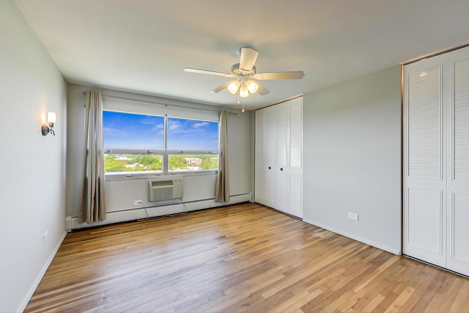 9009 Golf Road, Unit 8B Des Plaines, IL 60016 - Photo 27 of 42 a view of an empty room with window and wooden floor