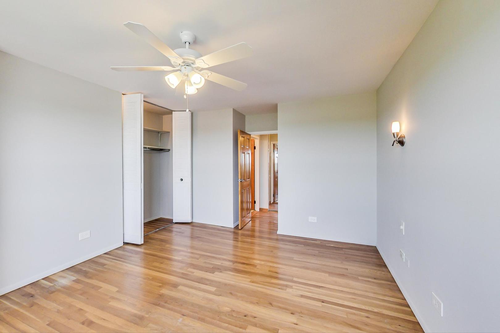9009 Golf Road, Unit 8B Des Plaines, IL 60016 - Photo 29 of 42 wooden floor in an empty room with a window
