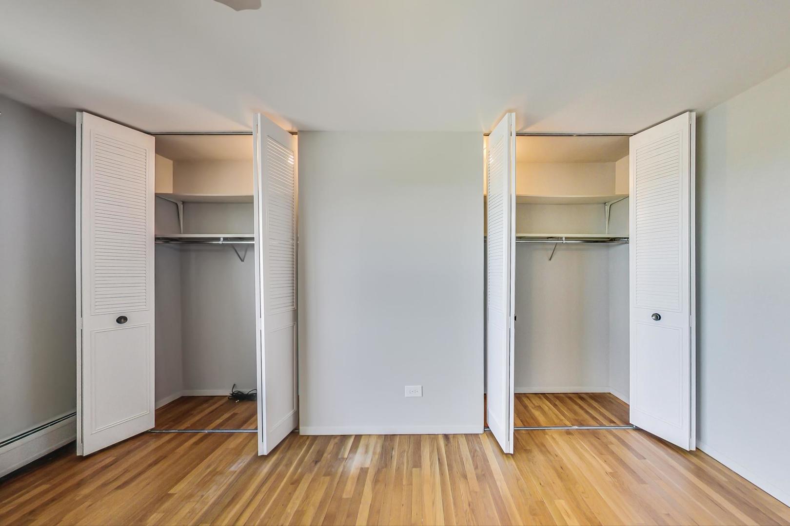9009 Golf Road, Unit 8B Des Plaines, IL 60016 - Photo 30 of 42 a view of walk in closet with wooden floor