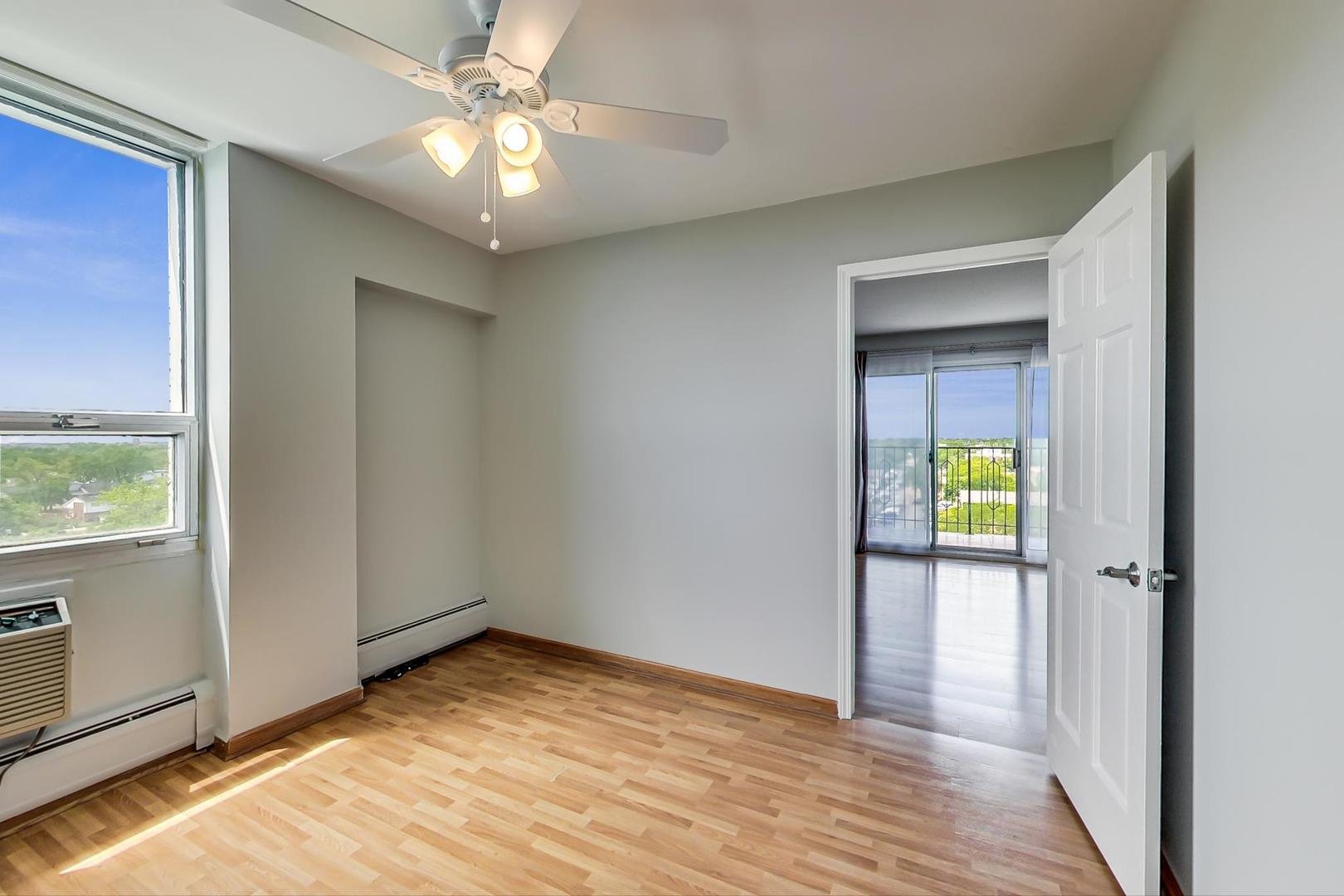 9009 Golf Road, Unit 8B Des Plaines, IL 60016 - Photo 34 of 42 wooden floor in an empty room with a window