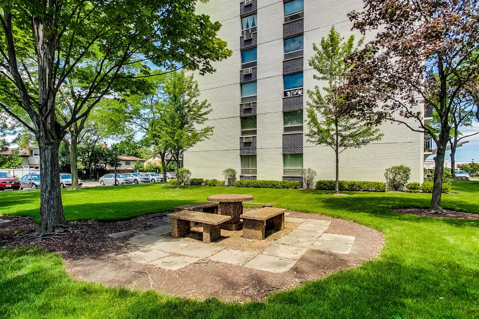 9009 Golf Road, Unit 8B Des Plaines, IL 60016 - Photo 38 of 42 a view of a chair and table in the garden