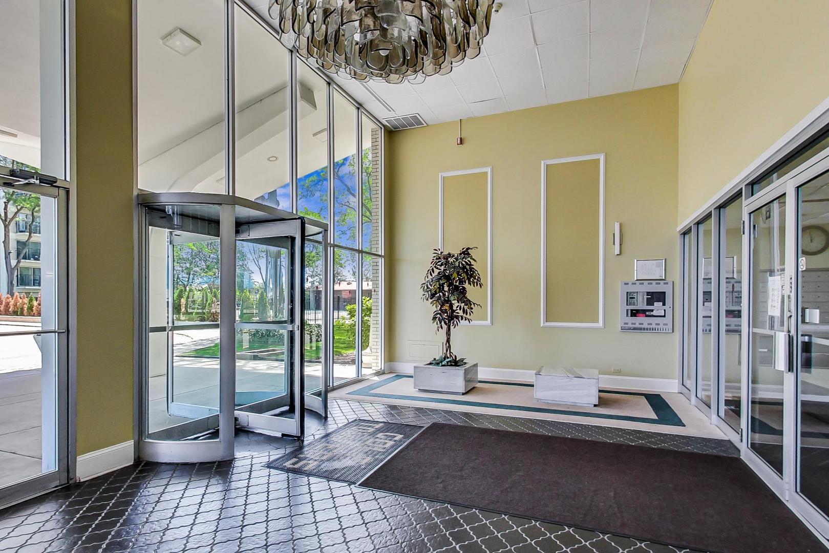 9009 Golf Road, Unit 8B Des Plaines, IL 60016 - Photo 7 of 42 a living room with a couch and a table