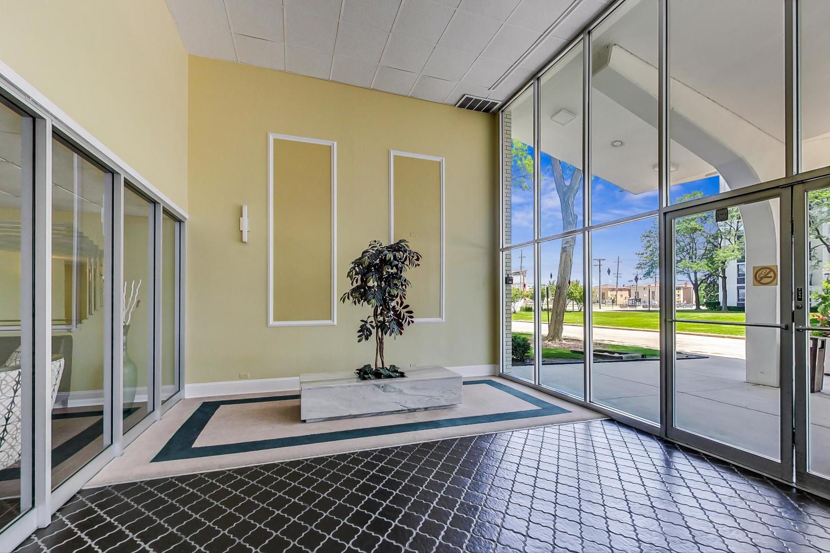 9009 Golf Road, Unit 8B Des Plaines, IL 60016 - Photo 8 of 42 a living room with a floor to ceiling window and wooden floor
