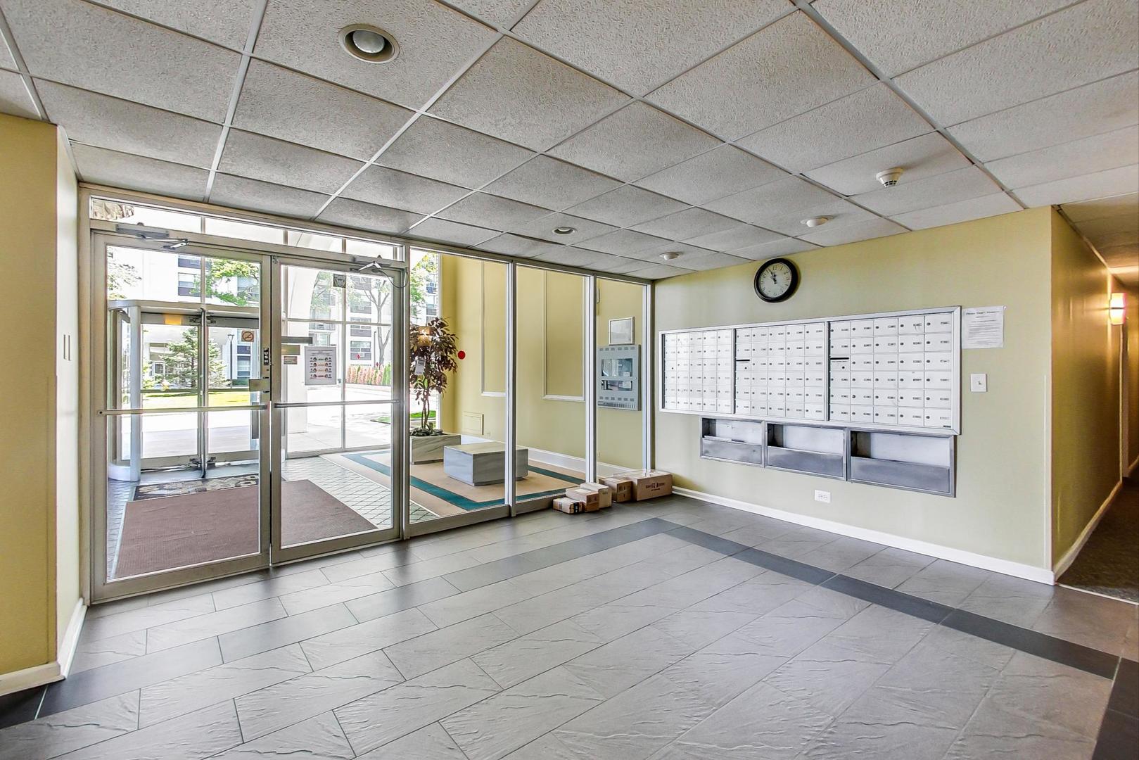 9009 Golf Road, Unit 8B Des Plaines, IL 60016 - Photo 9 of 42 a view of a room with gym equipment and large windows